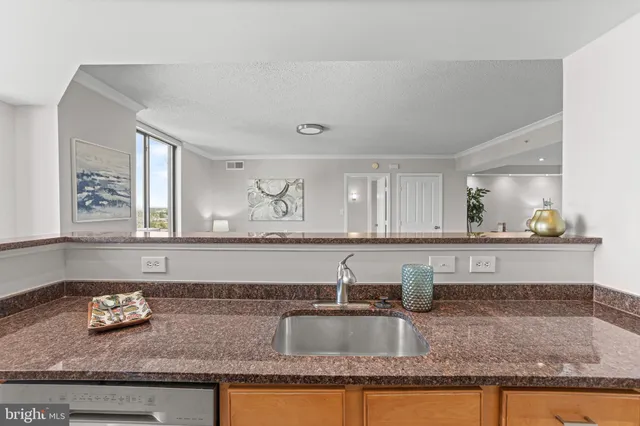a kitchen with granite countertop a sink and a stove