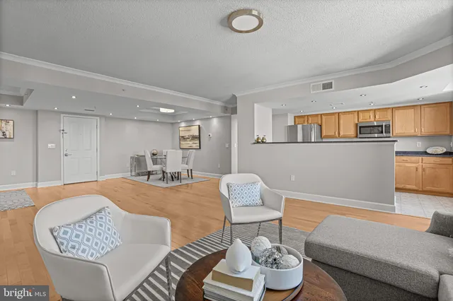 a living room with furniture and kitchen view