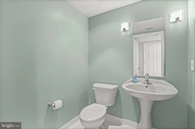 a bathroom with a sink mirror and toilet