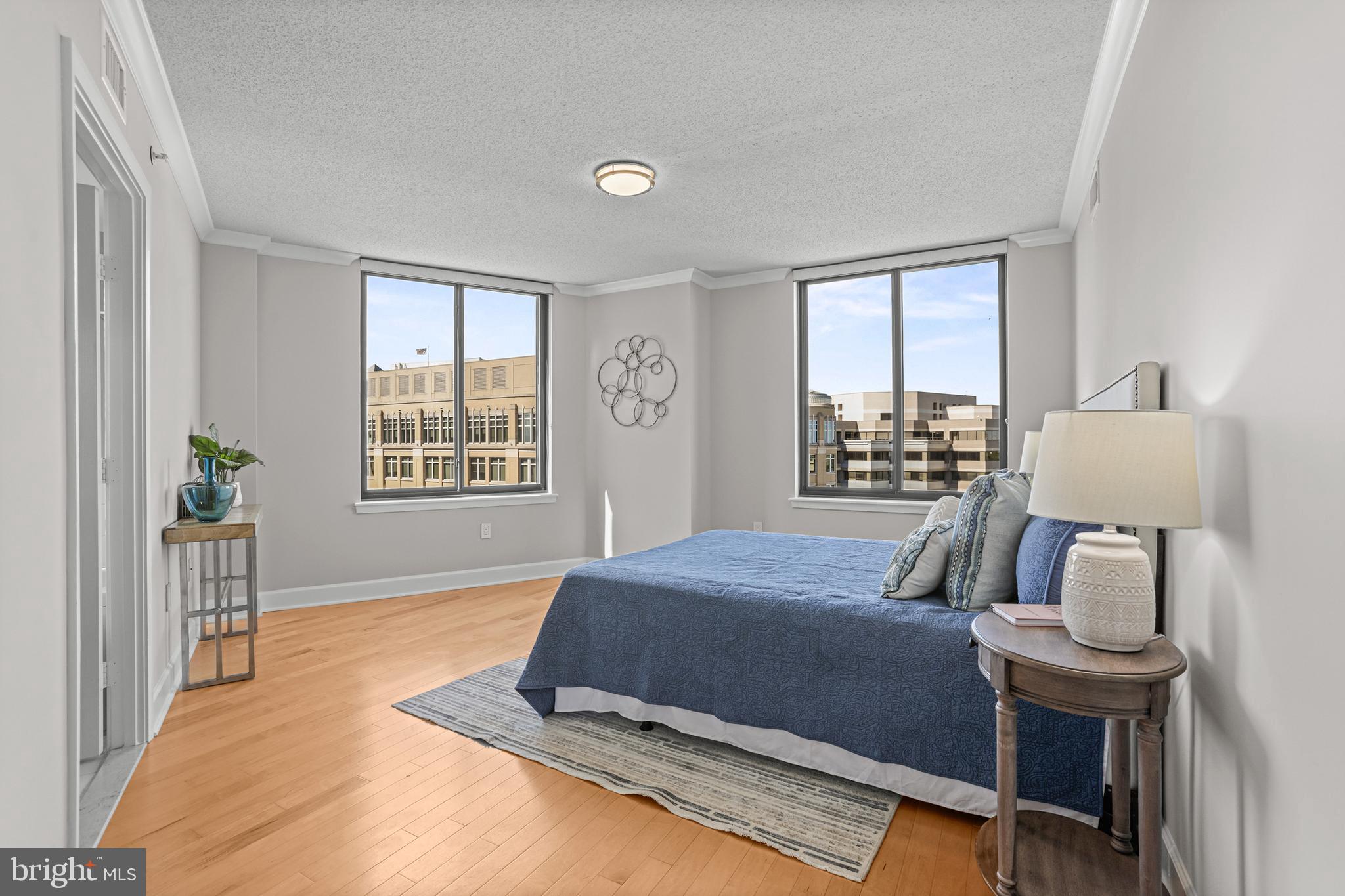 1220 North Fillmore Street, Unit 602 Arlington, VA 22201 - Photo 17 of 43 a bedroom with a bed and wooden floor