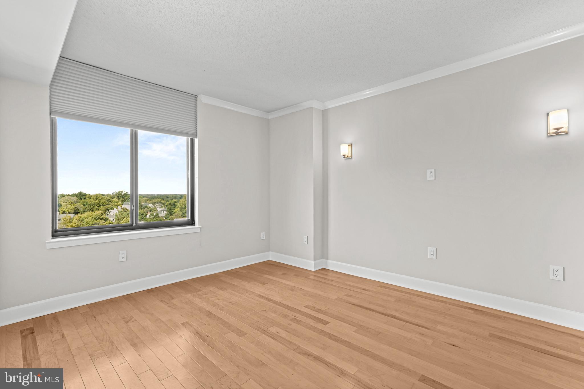 1220 North Fillmore Street, Unit 602 Arlington, VA 22201 - Photo 21 of 43 a view of an empty room with wooden floor and a window