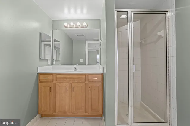 a bathroom with a double vanity sink mirror and shower