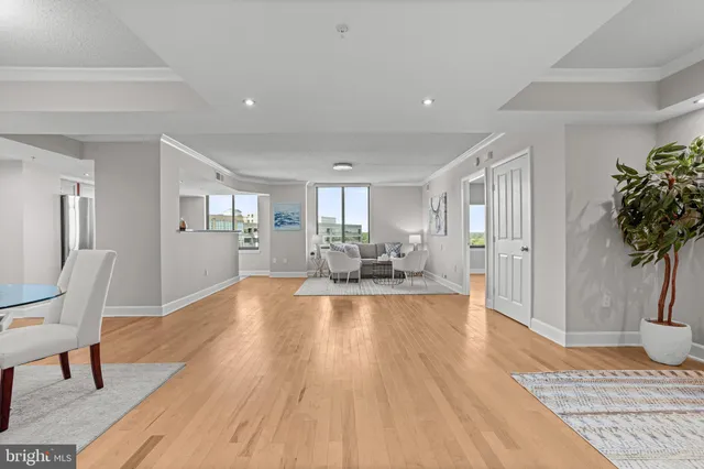 a view of a living room a dining room wooden floor and a rug