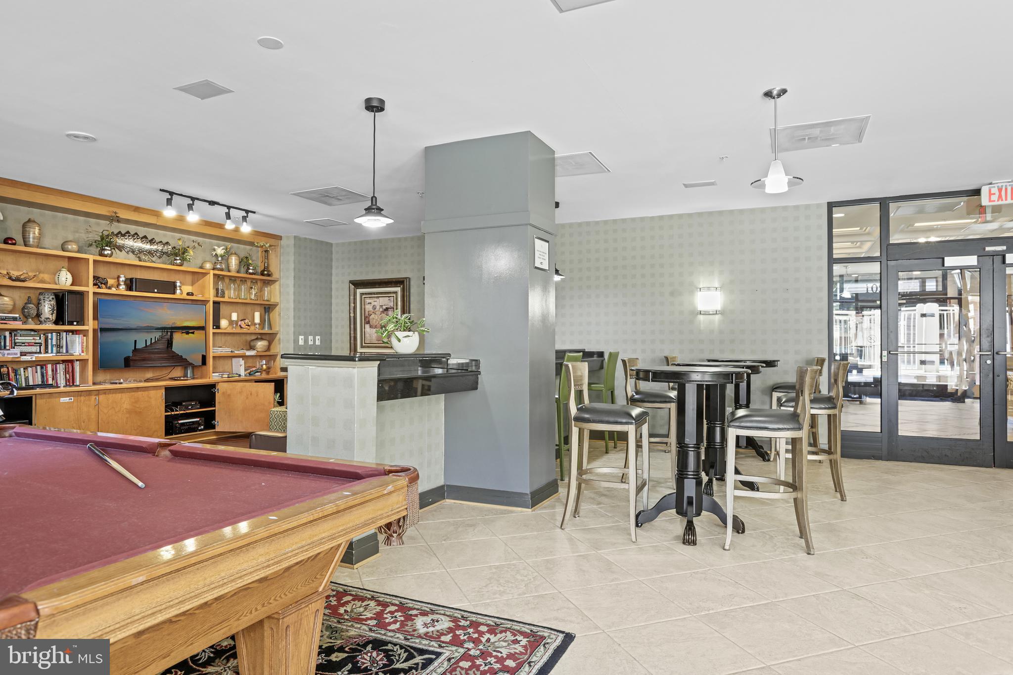 1220 North Fillmore Street, Unit 602 Arlington, VA 22201 - Photo 31 of 43 a room with stainless steel appliances kitchen island granite countertop dining table chairs and a large window