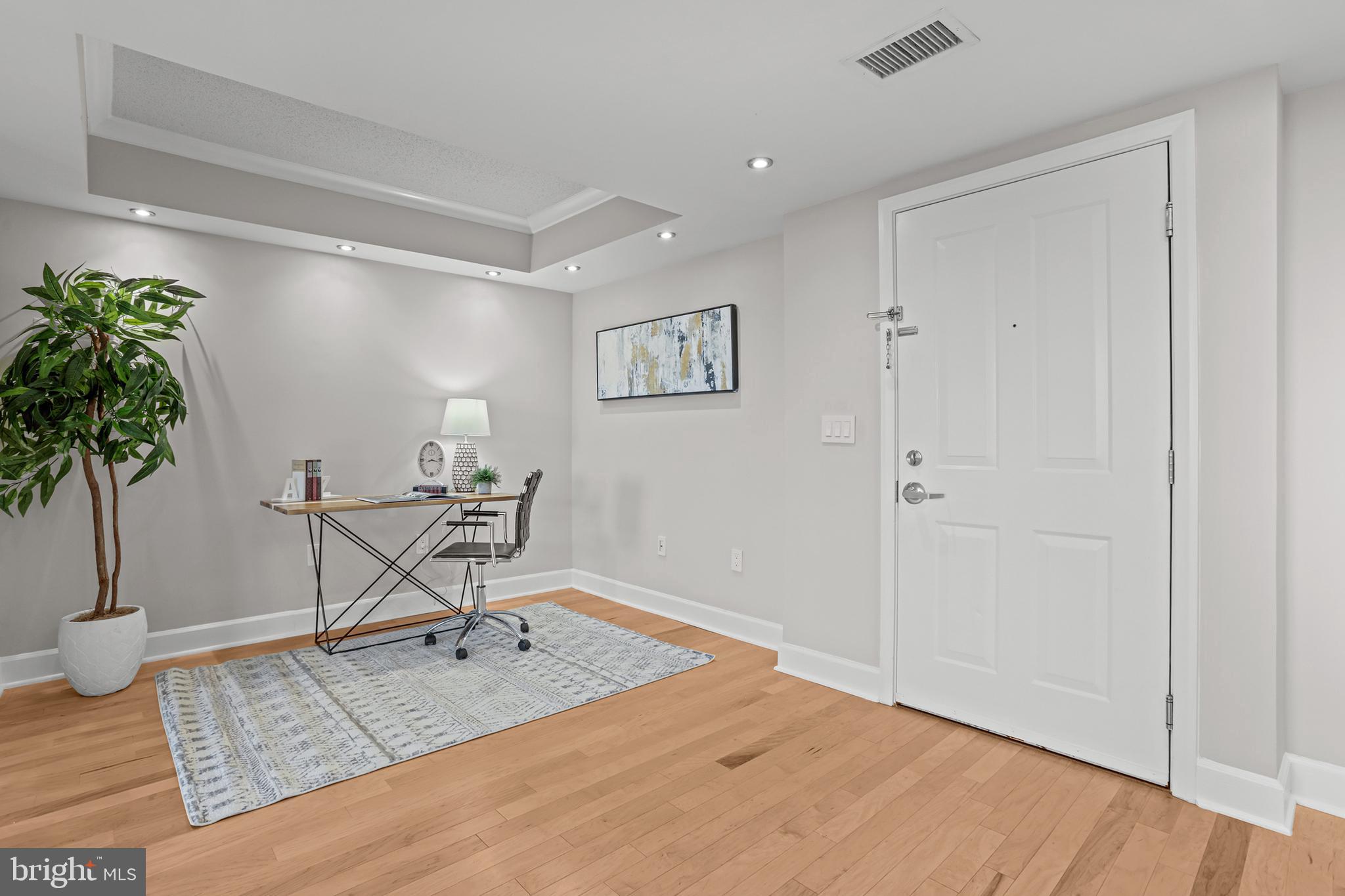 1220 North Fillmore Street, Unit 602 Arlington, VA 22201 - Photo 5 of 43 a workspace with furniture and a potted plant