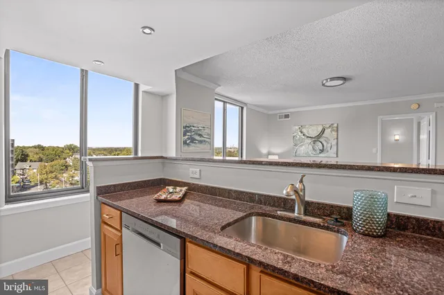 a bathroom with a granite countertop sink and a large mirror