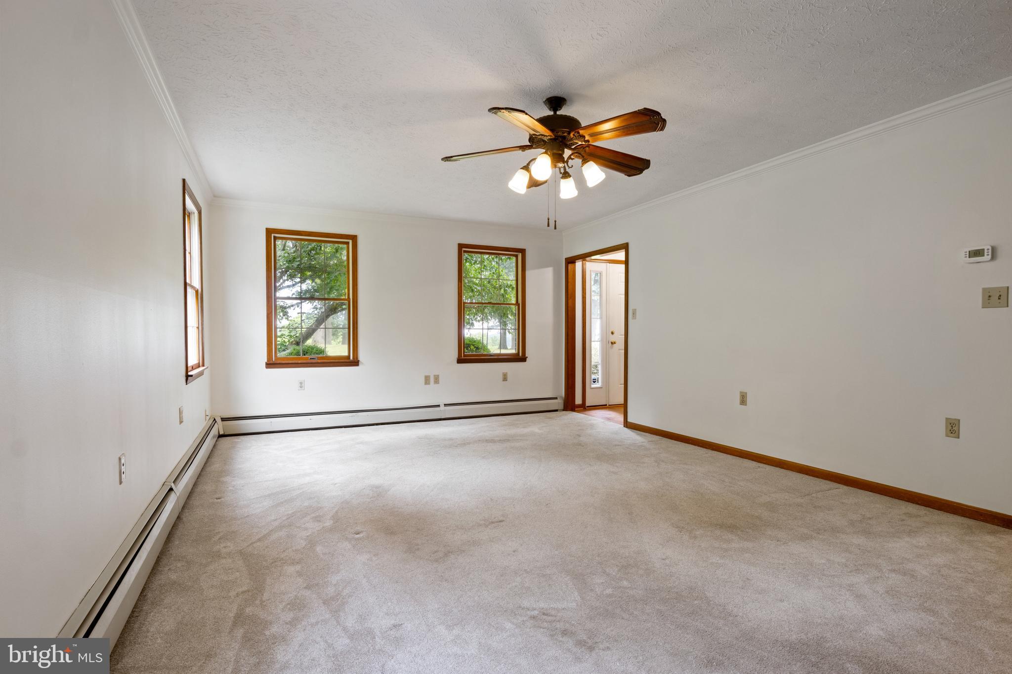 4850 Delta Road Delta, PA 17314 - Photo 24 of 74 an empty room with windows and chandelier fan