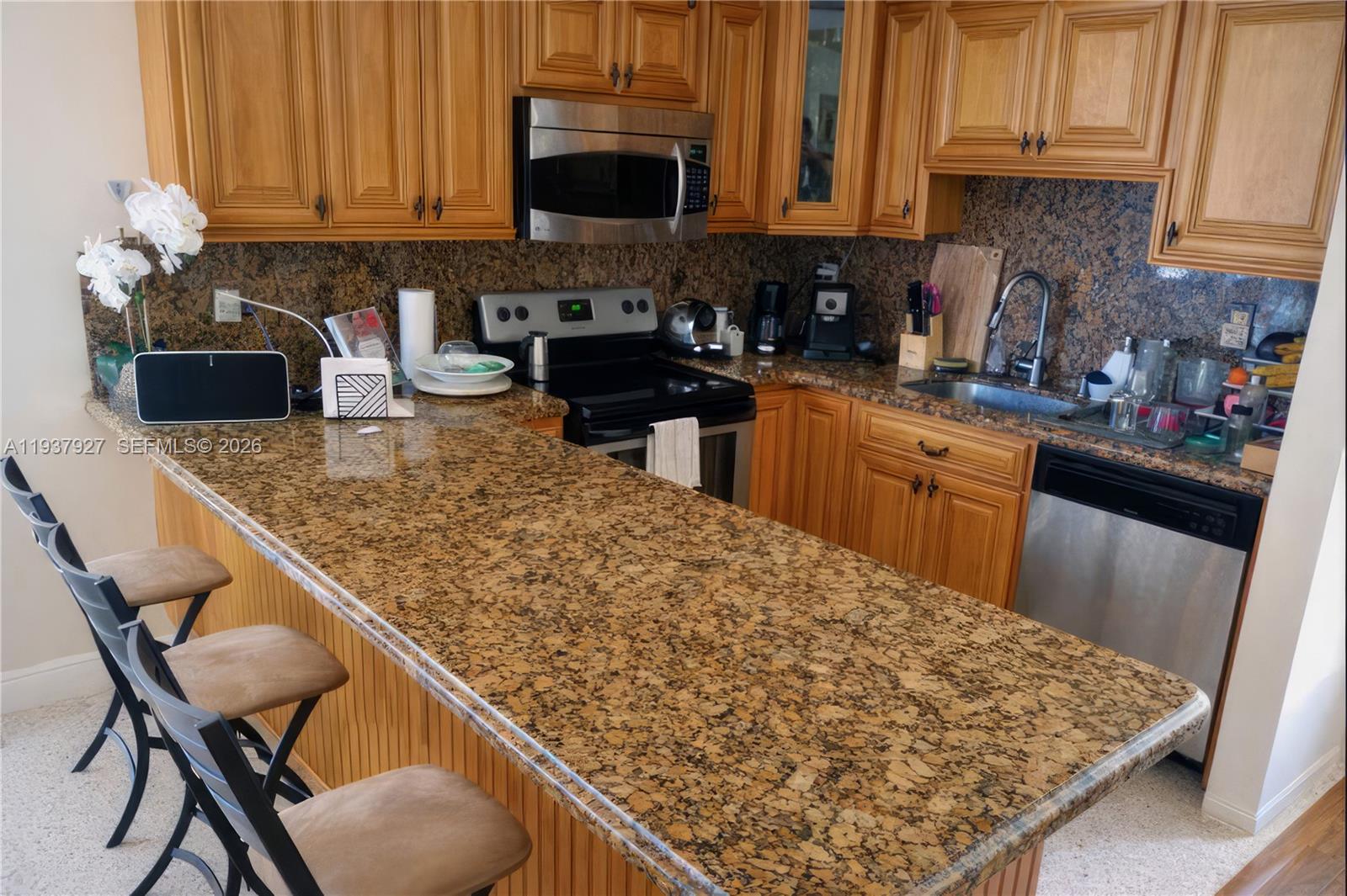12501 Southwest 90th Avenue Miami, FL 33176 - Photo 13 of 27 a kitchen with stainless steel appliances granite countertop a sink stove and microwave