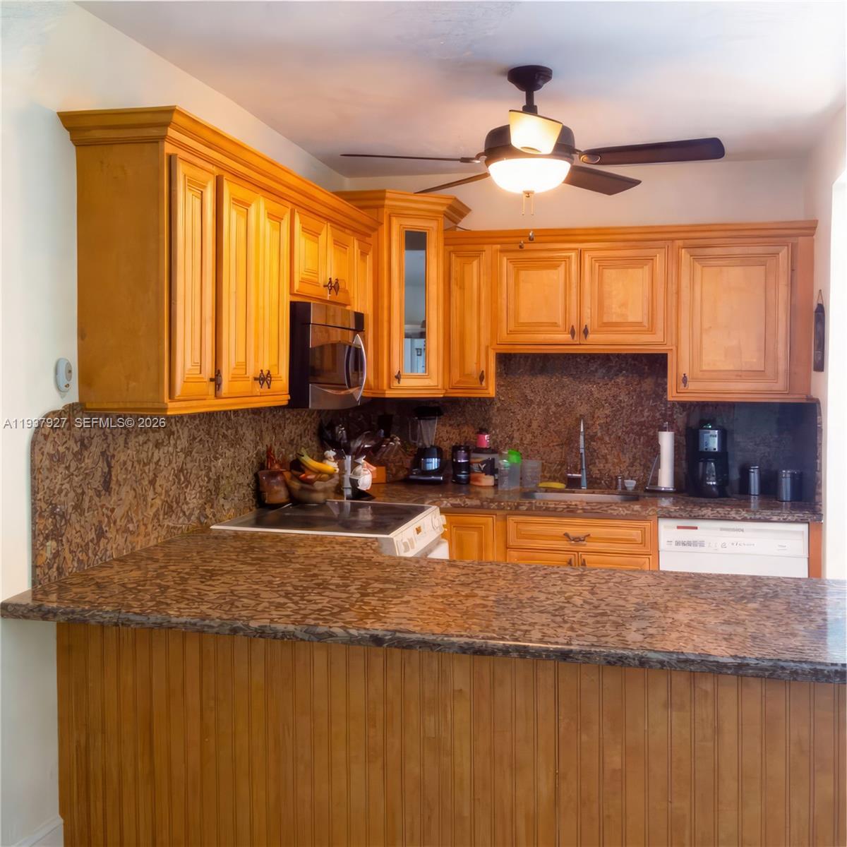 12501 Southwest 90th Avenue Miami, FL 33176 - Photo 14 of 27 a kitchen with stainless steel appliances granite countertop a sink a stove counter space and a window
