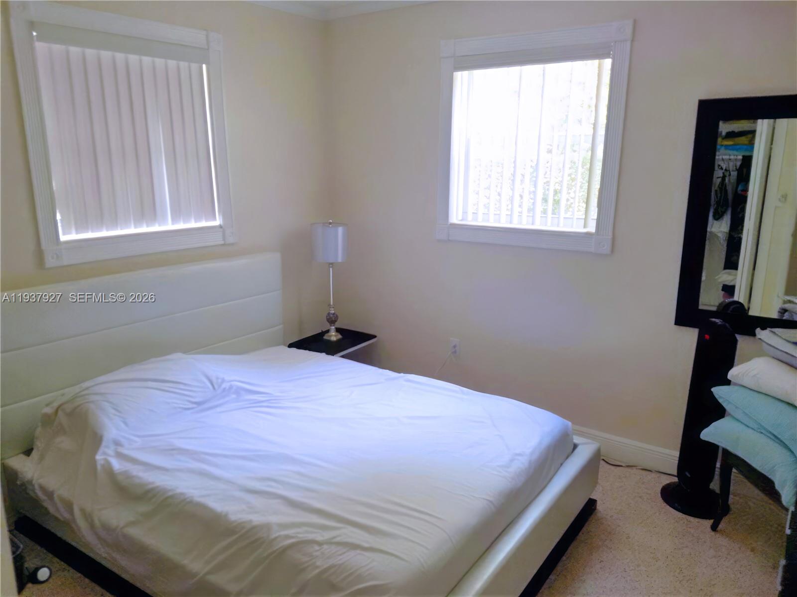 12501 Southwest 90th Avenue Miami, FL 33176 - Photo 18 of 27 a bedroom with a bed and a window