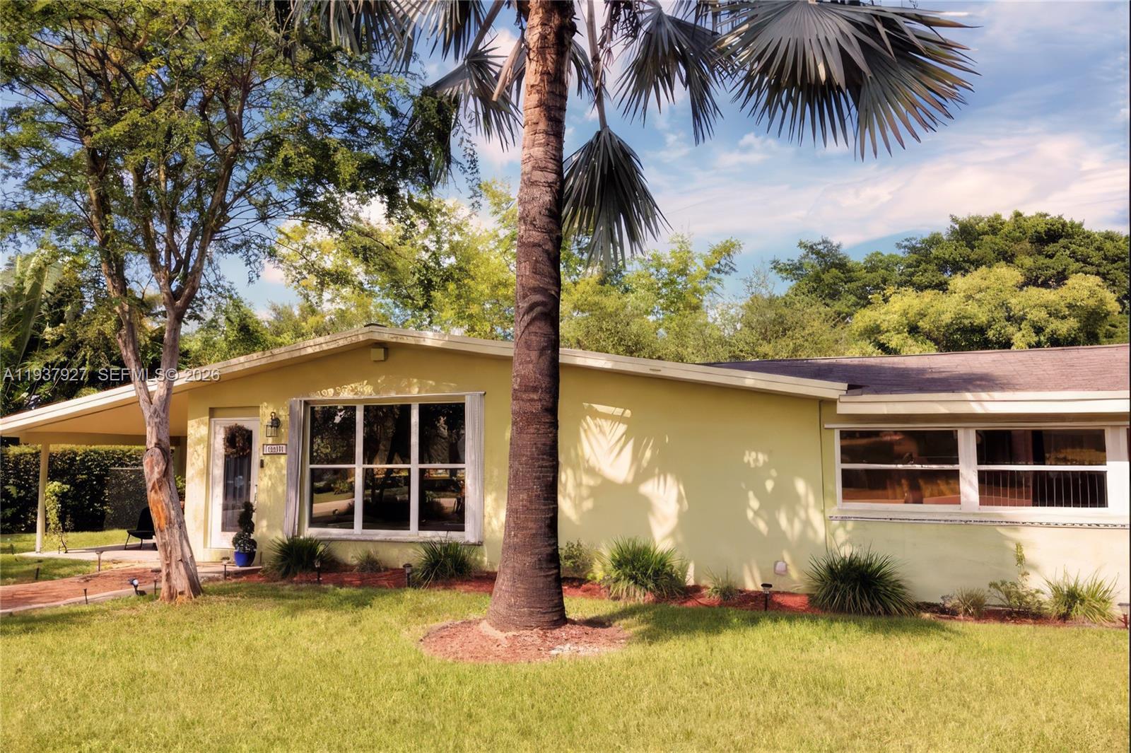 12501 Southwest 90th Avenue Miami, FL 33176 - Photo 5 of 27 a front view of a house with a yard
