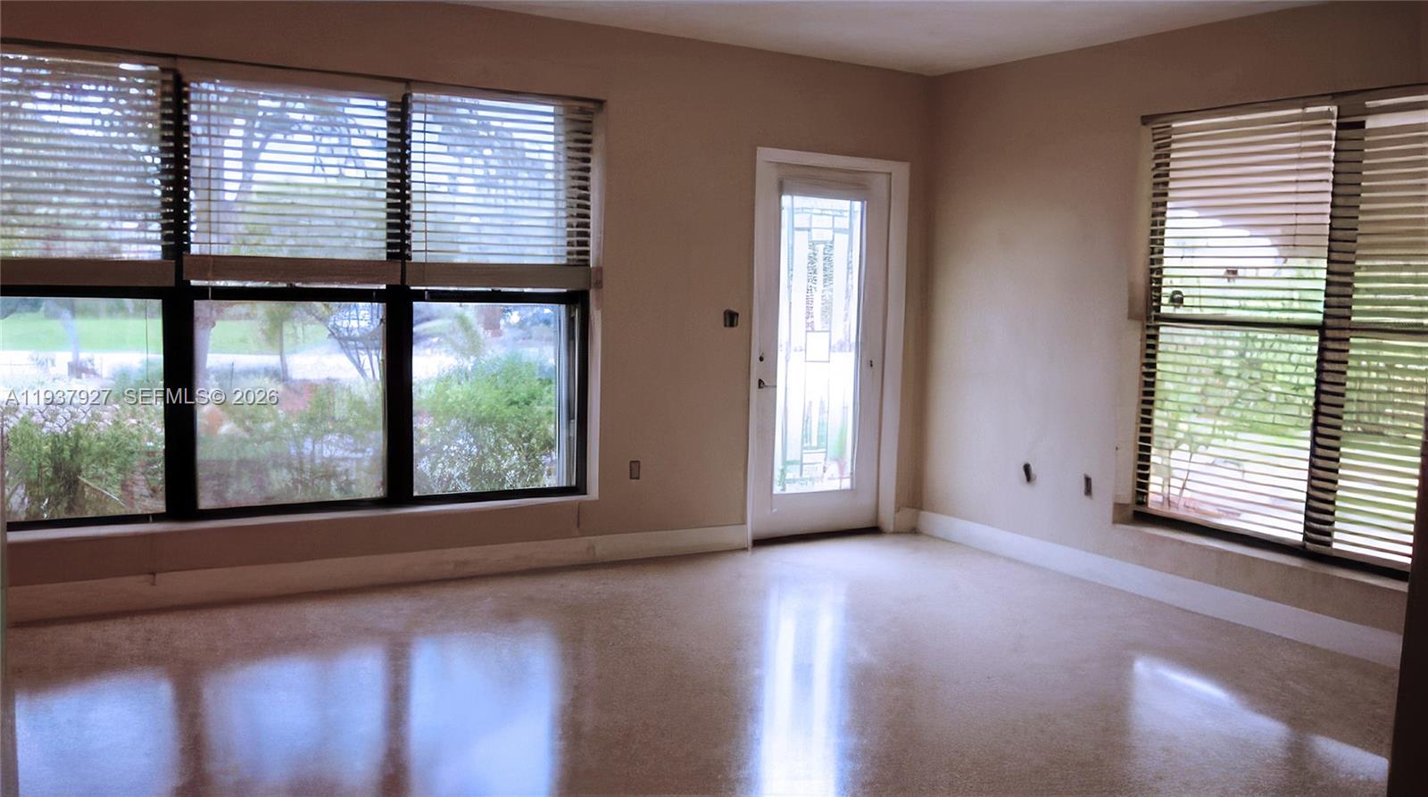 12501 Southwest 90th Avenue Miami, FL 33176 - Photo 8 of 27 a view of an empty room with a window and wooden floor