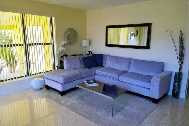 a view of a house with a yard garage and sitting area