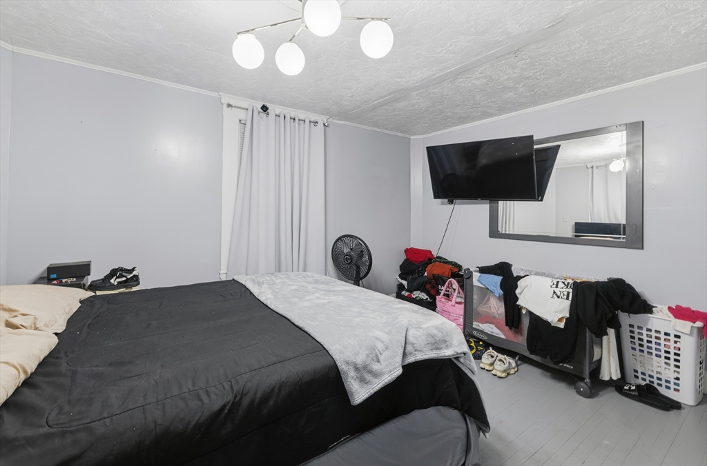 62 Main Street Saugus, MA 01906 - Photo 12 of 24 a bedroom with a bed and a flat screen tv