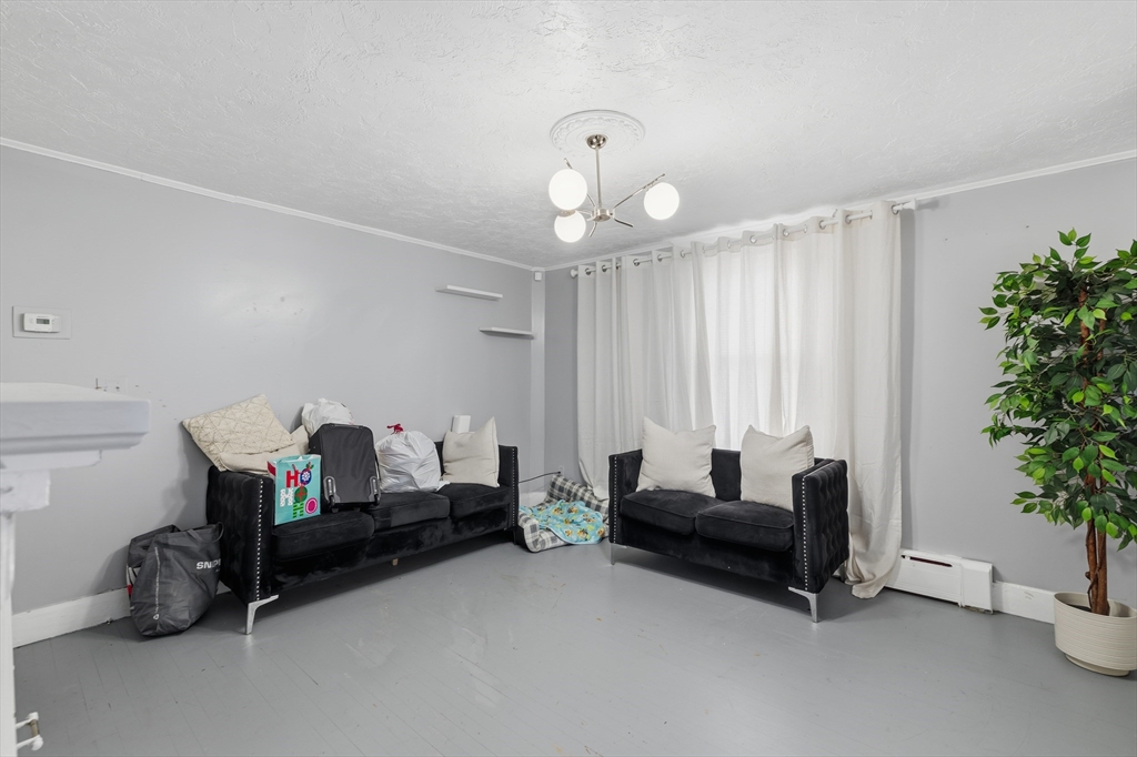 62 Main Street Saugus, MA 01906 - Photo 8 of 24 a living room with furniture and flowers