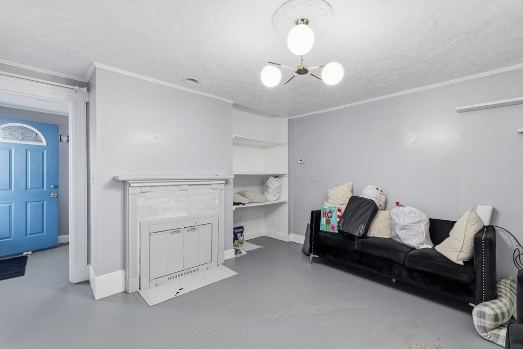 62 Main Street Saugus, MA 01906 - Photo 9 of 24 a bedroom with furniture and a chandelier fan