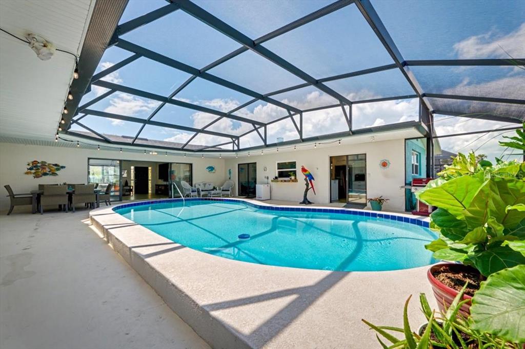 124 Anchor Drive Ponce Inlet, FL 32127 - Photo 19 of 77 a view of a patio with table and chairs potted plants with wooden floor