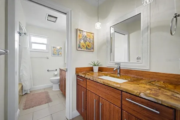 a bathroom with a toilet and a shower curtain