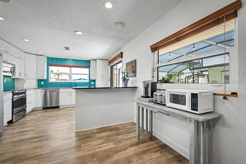 124 Anchor Drive Ponce Inlet, FL 32127 - Photo 23 of 77 a kitchen with stainless steel appliances granite countertop a stove and a refrigerator