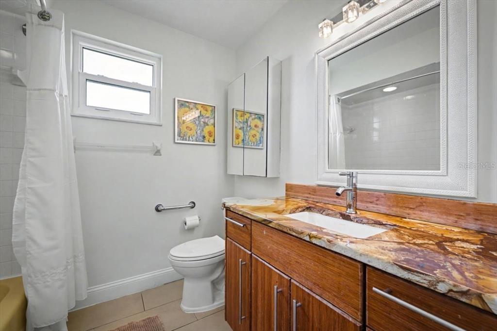 124 Anchor Drive Ponce Inlet, FL 32127 - Photo 24 of 77 a bathroom with a granite countertop sink toilet and mirror