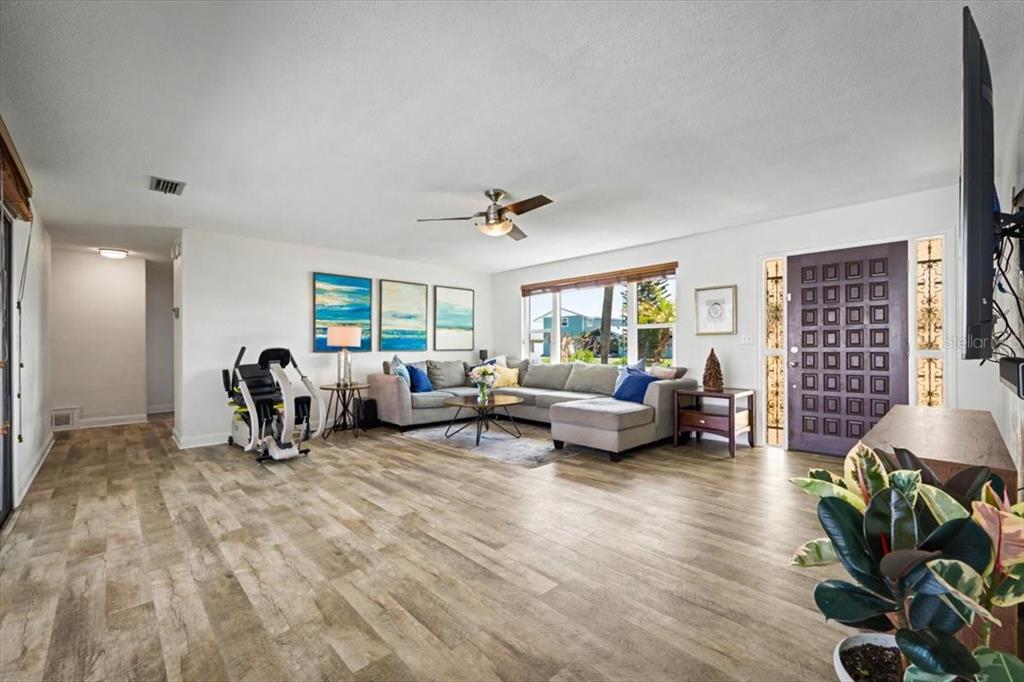124 Anchor Drive Ponce Inlet, FL 32127 - Photo 3 of 77 a living room with furniture and a wooden floor