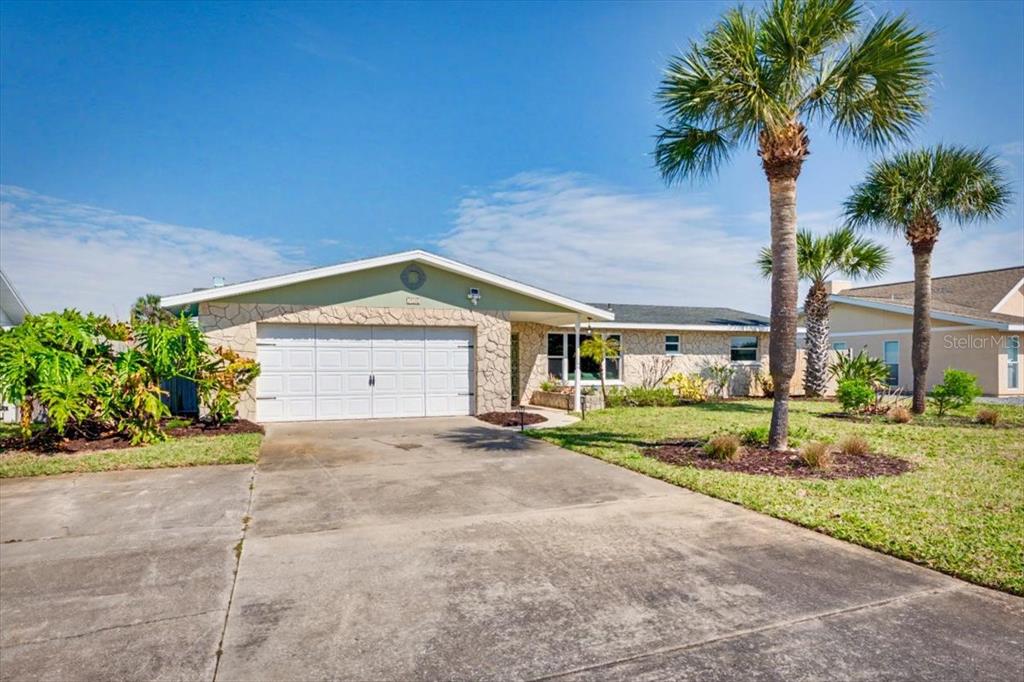 124 Anchor Drive Ponce Inlet, FL 32127 - Photo 49 of 77 a view of a house with a yard and palm trees