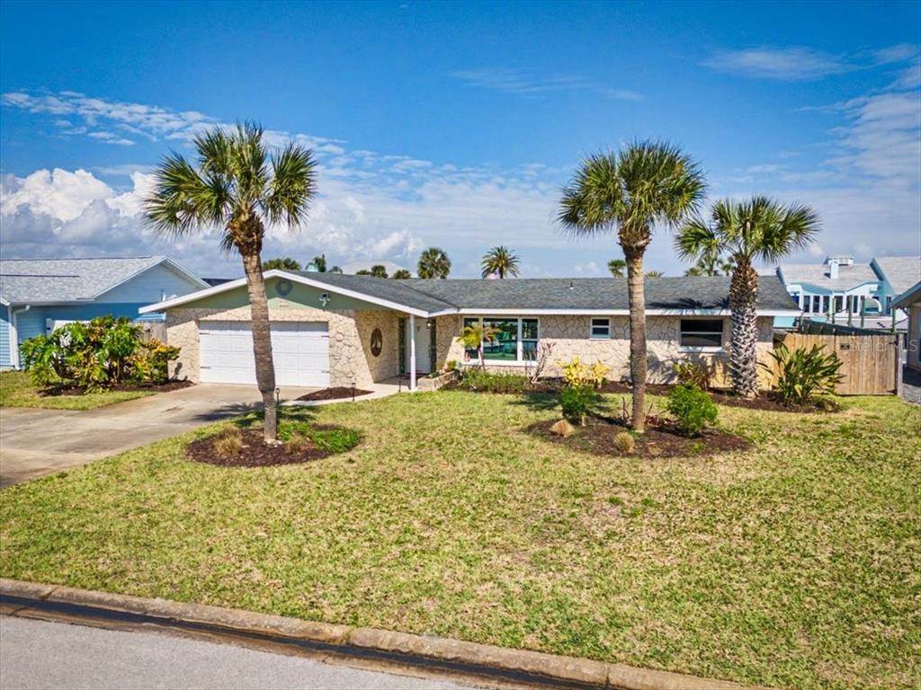 124 Anchor Drive Ponce Inlet, FL 32127 - Photo 60 of 77 a front view of a house with garden