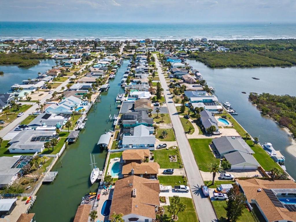 124 Anchor Drive Ponce Inlet, FL 32127 - Photo 68 of 77 an aerial view of a city with lots of residential buildings and lake view