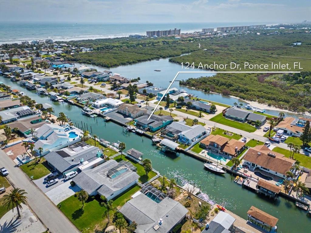 124 Anchor Drive Ponce Inlet, FL 32127 - Photo 70 of 77 an aerial view of a city with a lake view