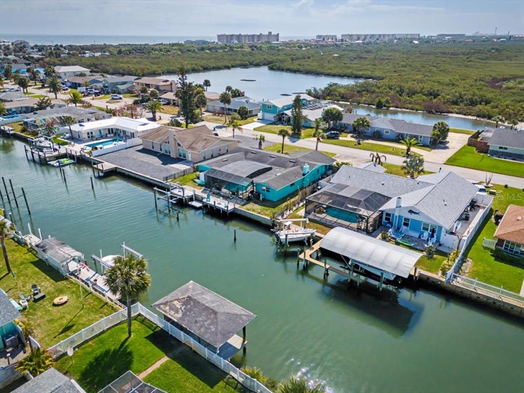 124 Anchor Drive Ponce Inlet, FL 32127 - Photo 10 of 77 an aerial view of residential houses with outdoor space and lake view