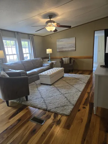 a living room with furniture and a large mirror