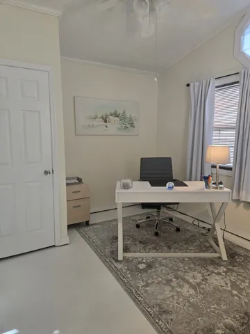 a living room with furniture and a lamp