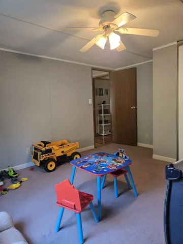 a spacious bedroom with a bed and a window