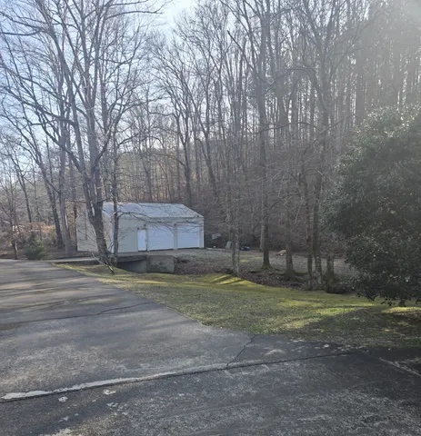 a view of a porch with furniture and a yard