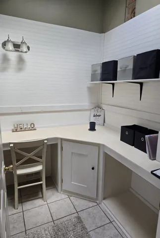 a kitchen with a refrigerator and a wooden floor