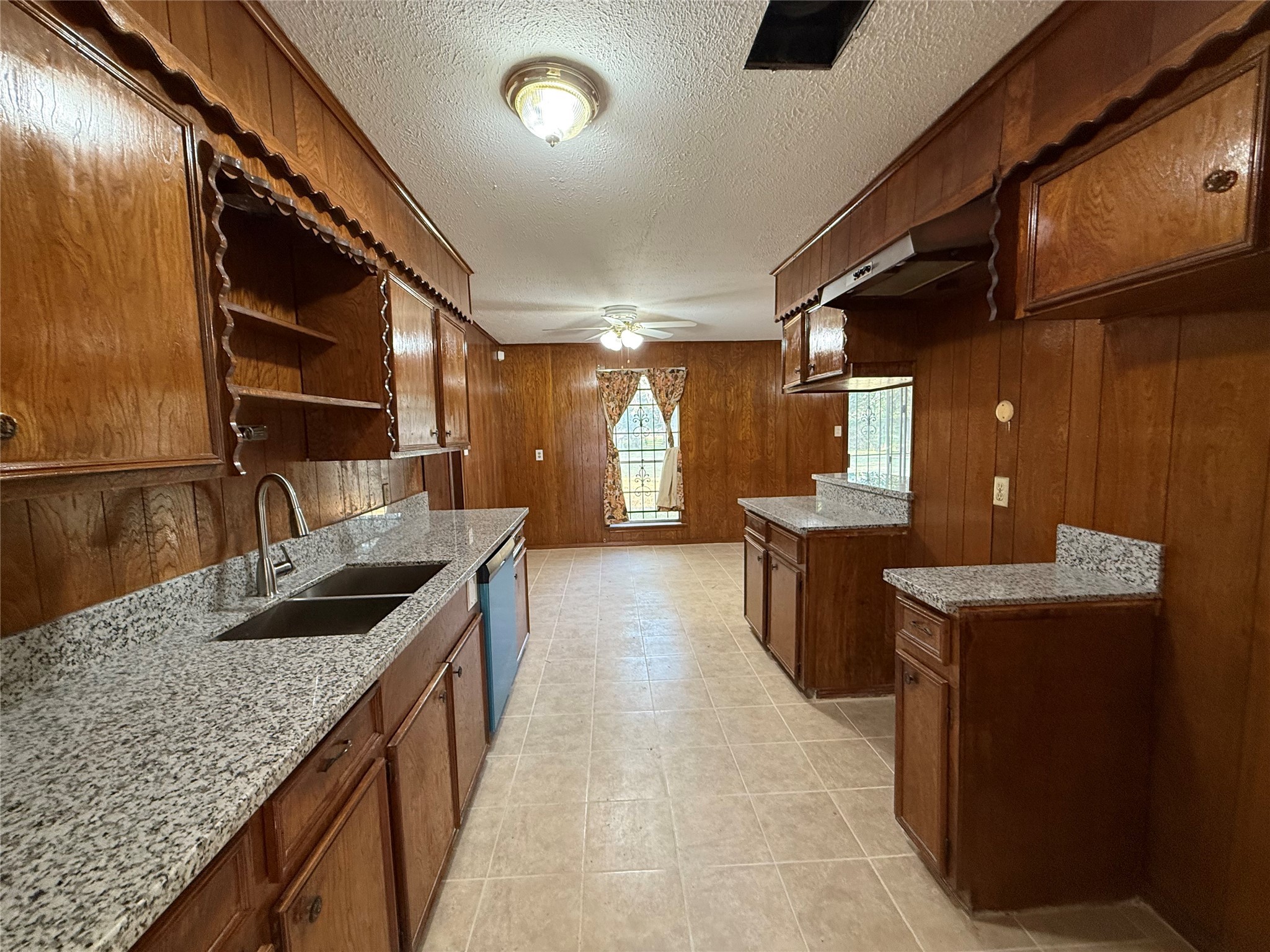 7325 Ley Road Houston, TX 77028 - Photo 14 of 50 a kitchen with granite countertop sink stove and cabinets