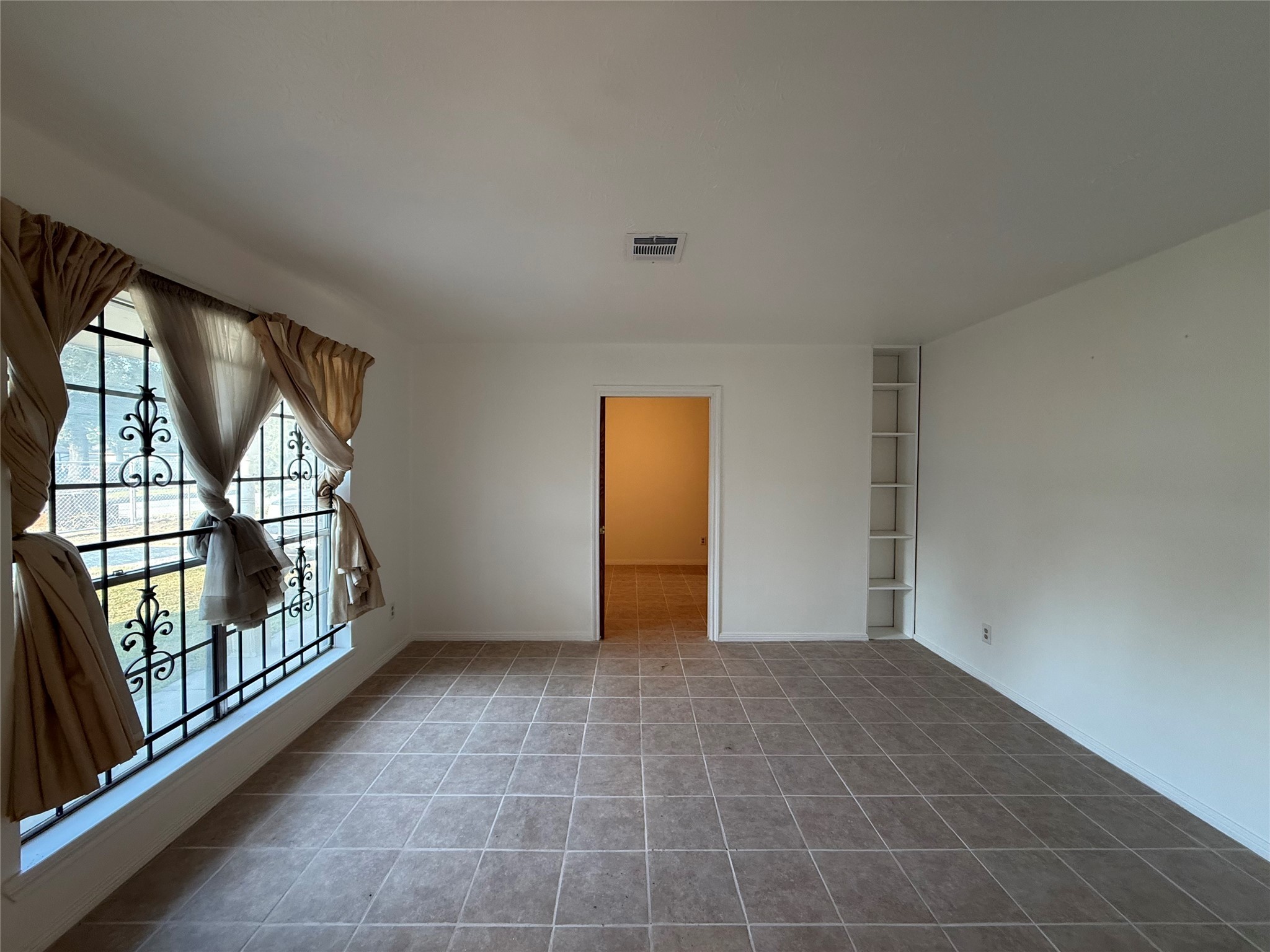 7325 Ley Road Houston, TX 77028 - Photo 3 of 50 a view of an empty room with glass door