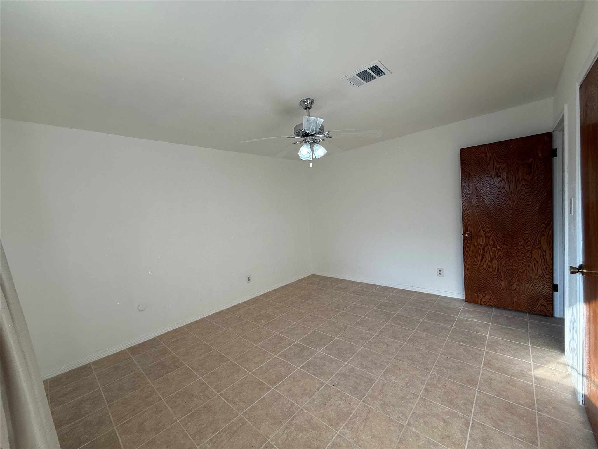7325 Ley Road Houston, TX 77028 - Photo 37 of 50 an empty room with a chandelier fan and closet