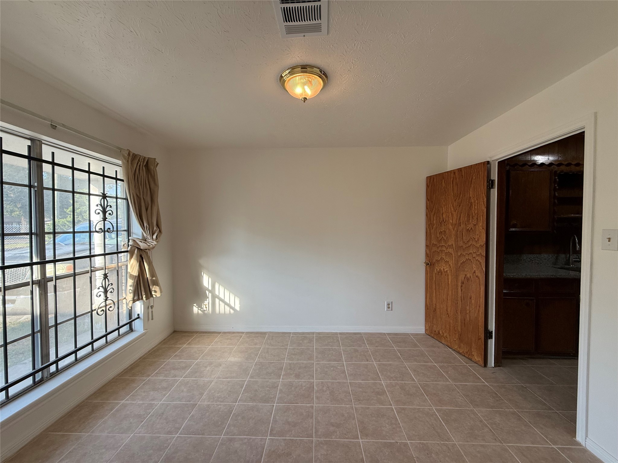 7325 Ley Road Houston, TX 77028 - Photo 4 of 50 a view of an empty room with a window