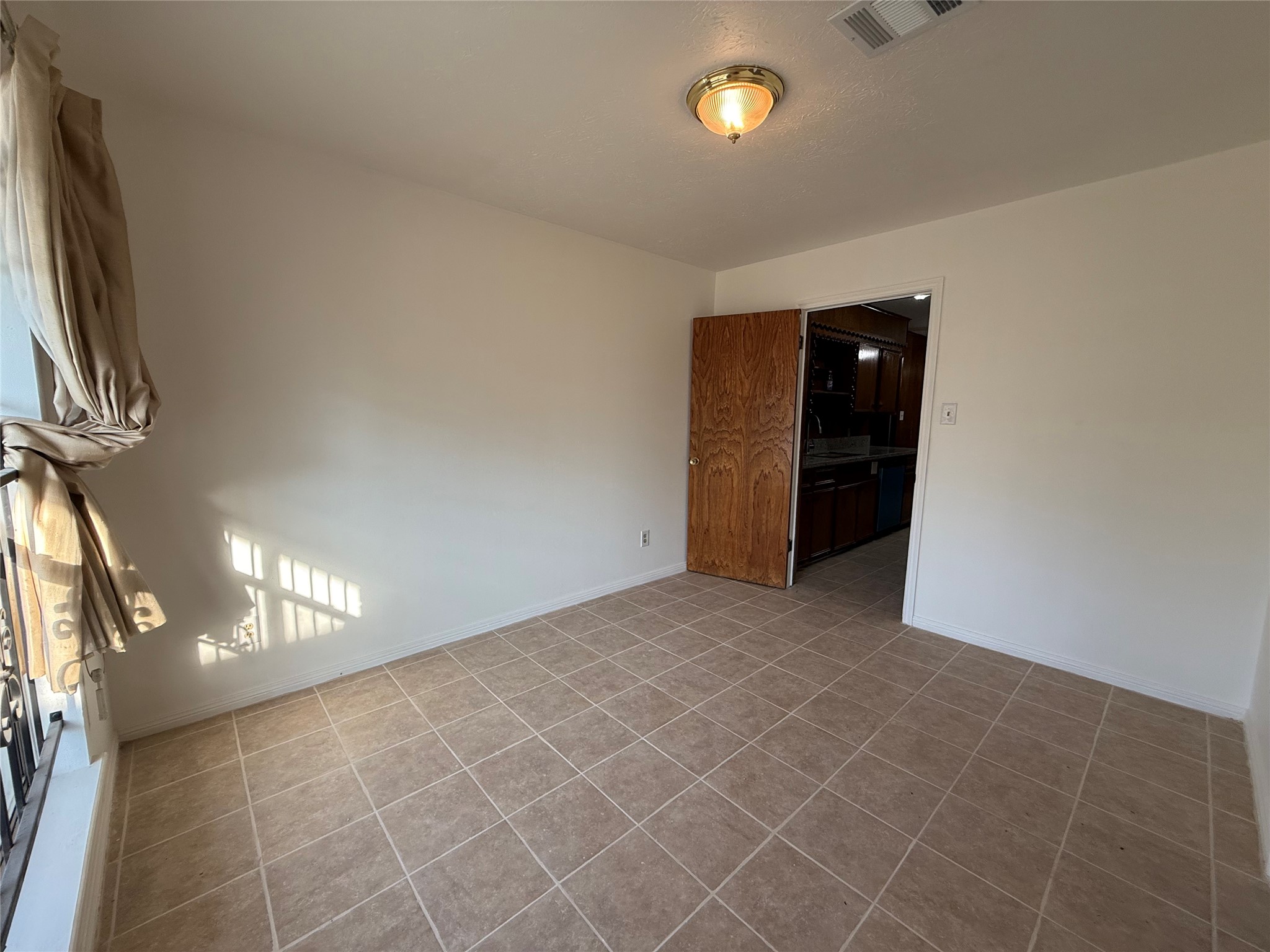 7325 Ley Road Houston, TX 77028 - Photo 5 of 50 a view of an empty room with a kitchen