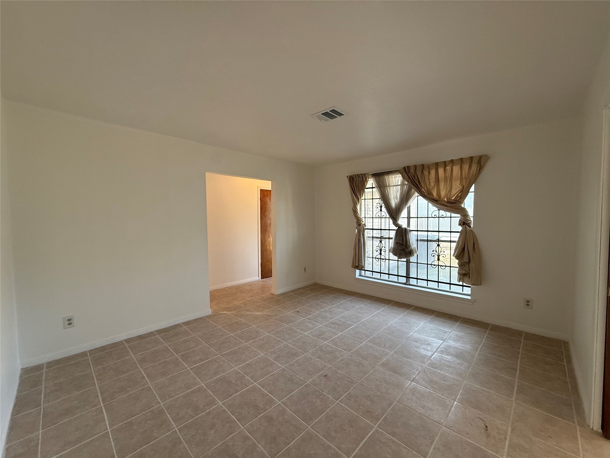 7325 Ley Road Houston, TX 77028 - Photo 7 of 50 a view of an empty room with a window