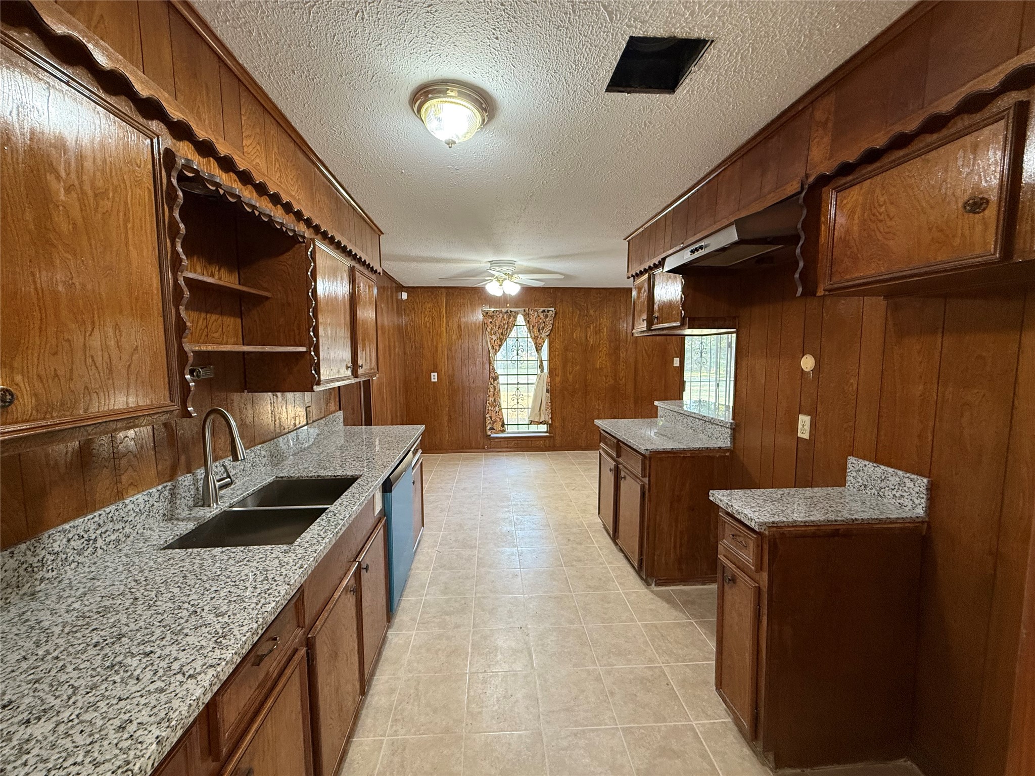 7325 Ley Road Houston, TX 77028 - Photo 9 of 50 a kitchen with granite countertop sink and cabinets