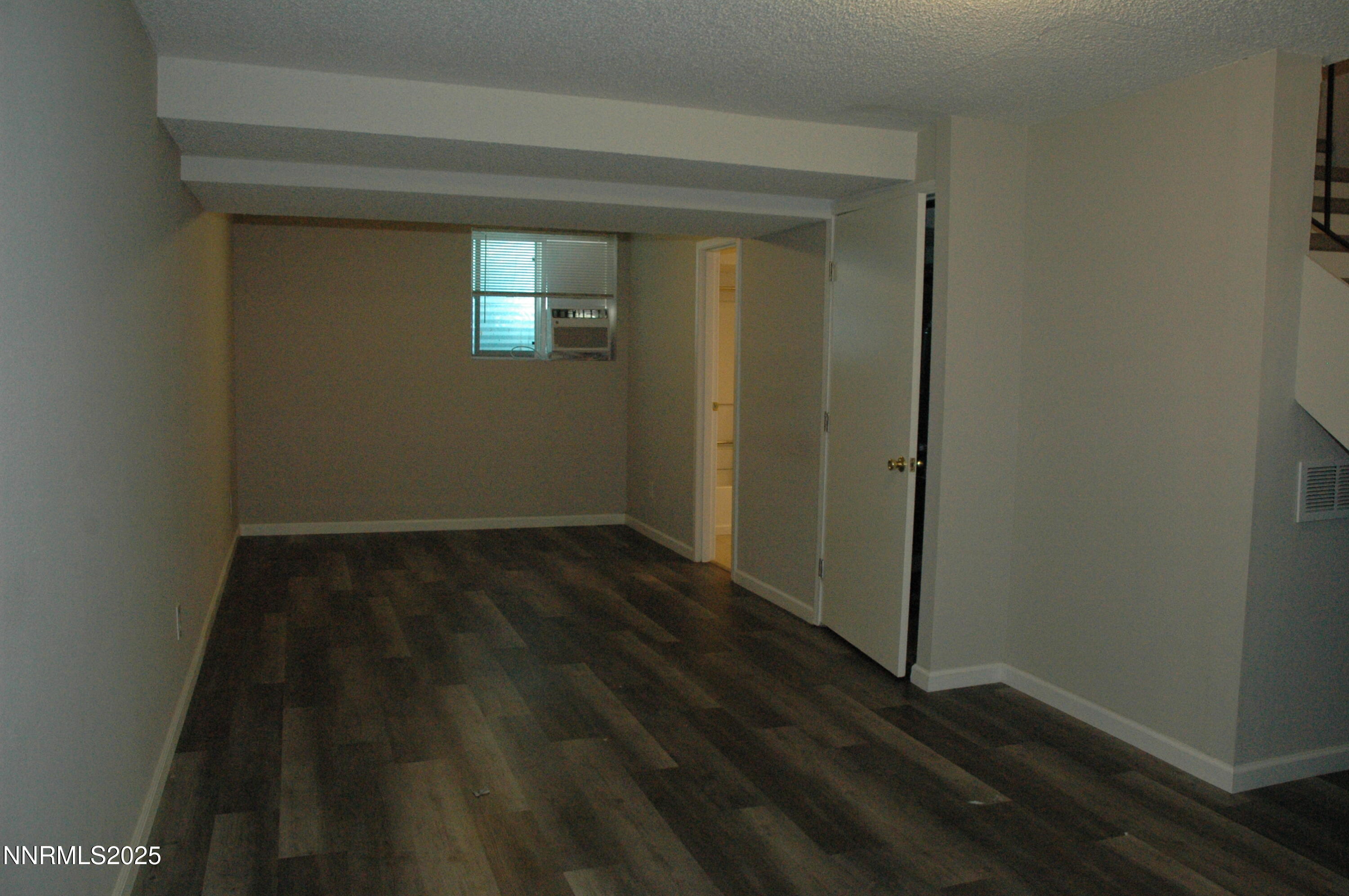 1424 East 9th Street, Unit 2 Reno, NV 89512 - Photo 13 of 20 an empty room with wooden floor and a window