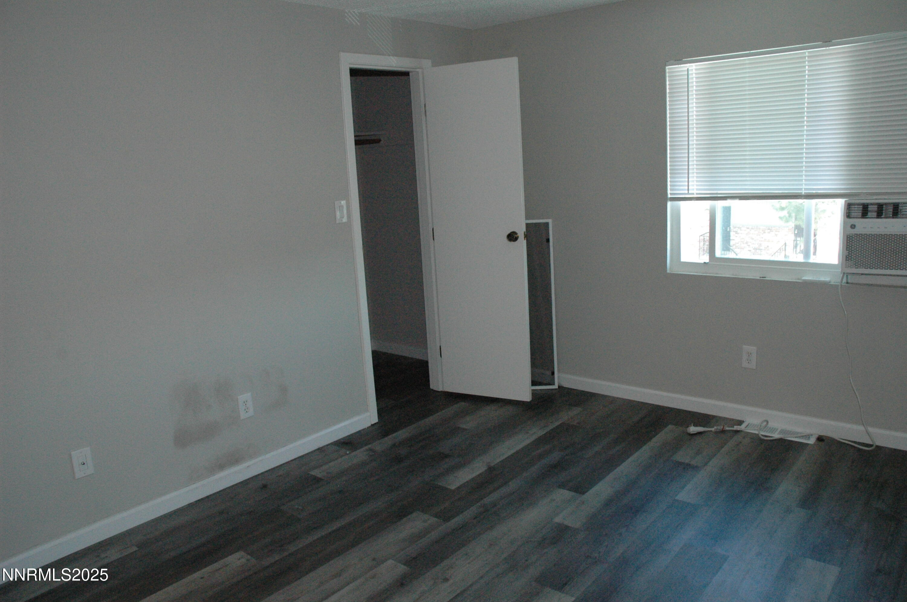 1424 East 9th Street, Unit 2 Reno, NV 89512 - Photo 17 of 20 an empty room with wooden floor and windows