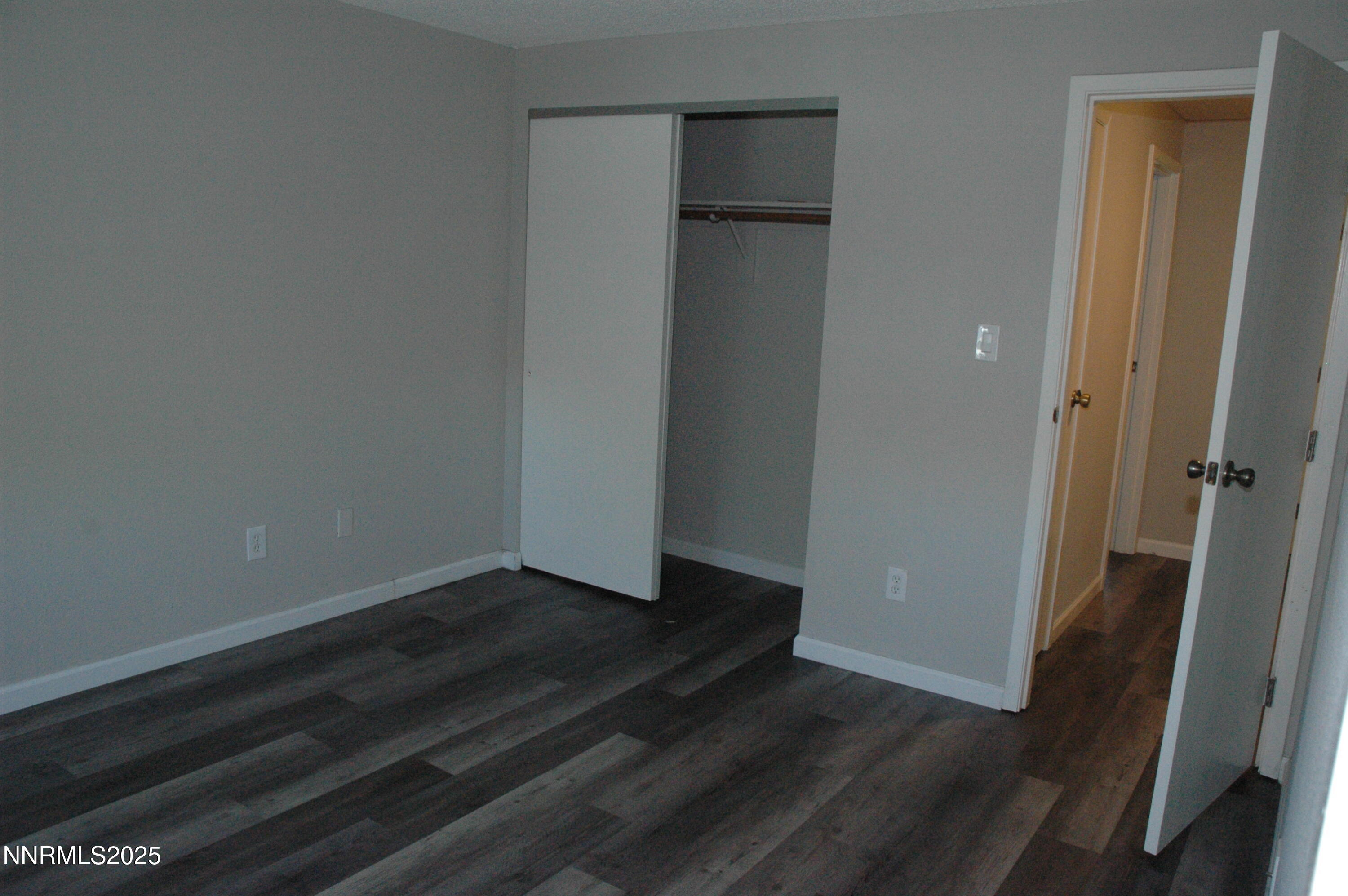 1424 East 9th Street, Unit 2 Reno, NV 89512 - Photo 20 of 20 a view of an empty room with wooden floor and a bathroom