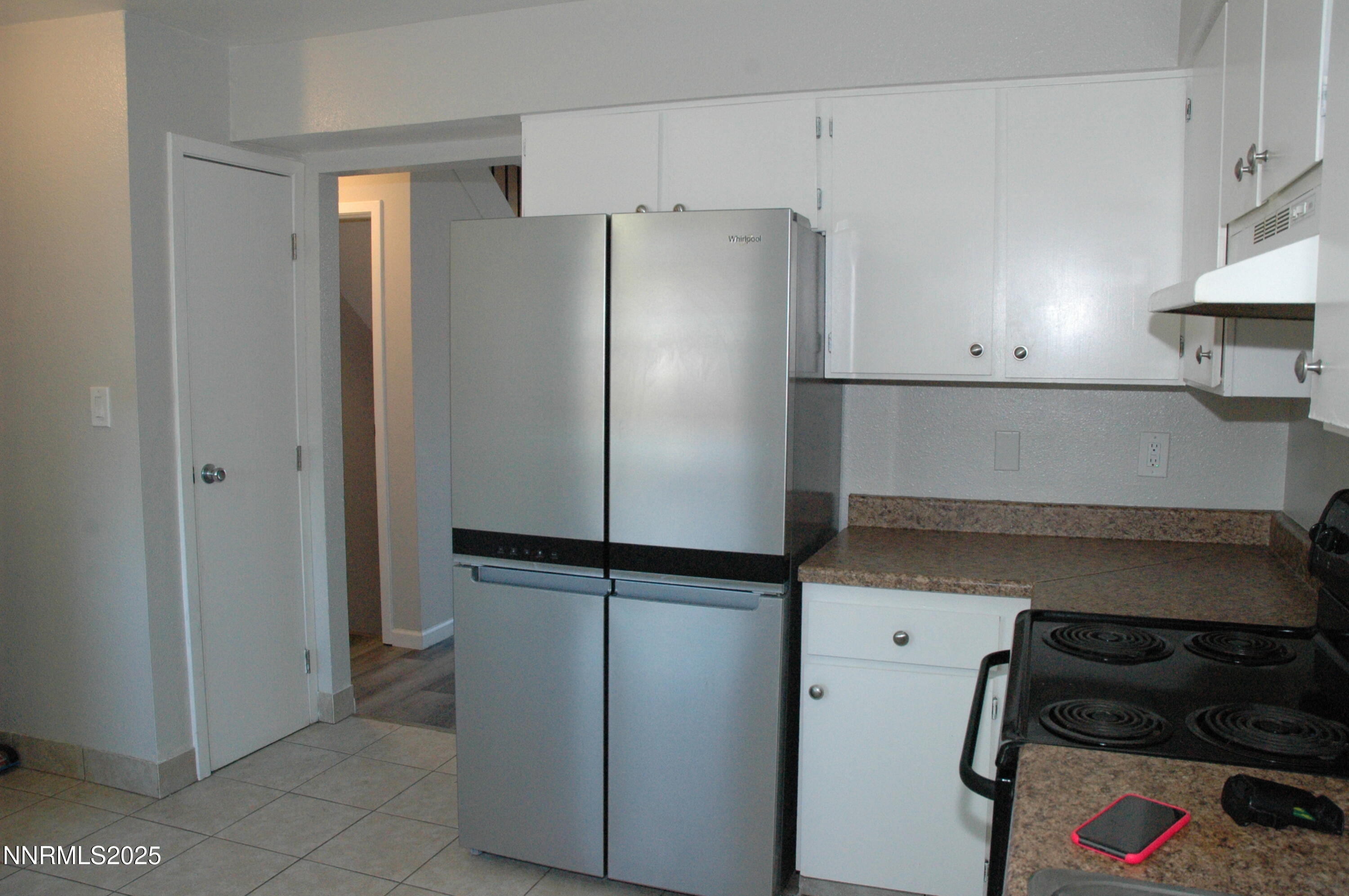 1424 East 9th Street, Unit 2 Reno, NV 89512 - Photo 6 of 20 a kitchen with metallic refrigerator freezer and a stove
