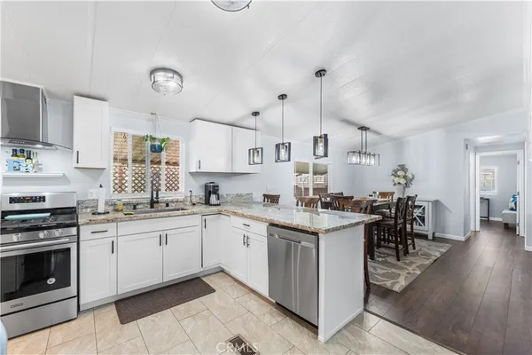 a kitchen with appliances a sink and cabinets