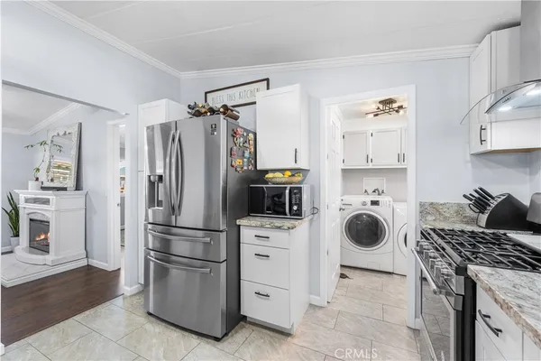 a kitchen with a refrigerator and a stove top oven