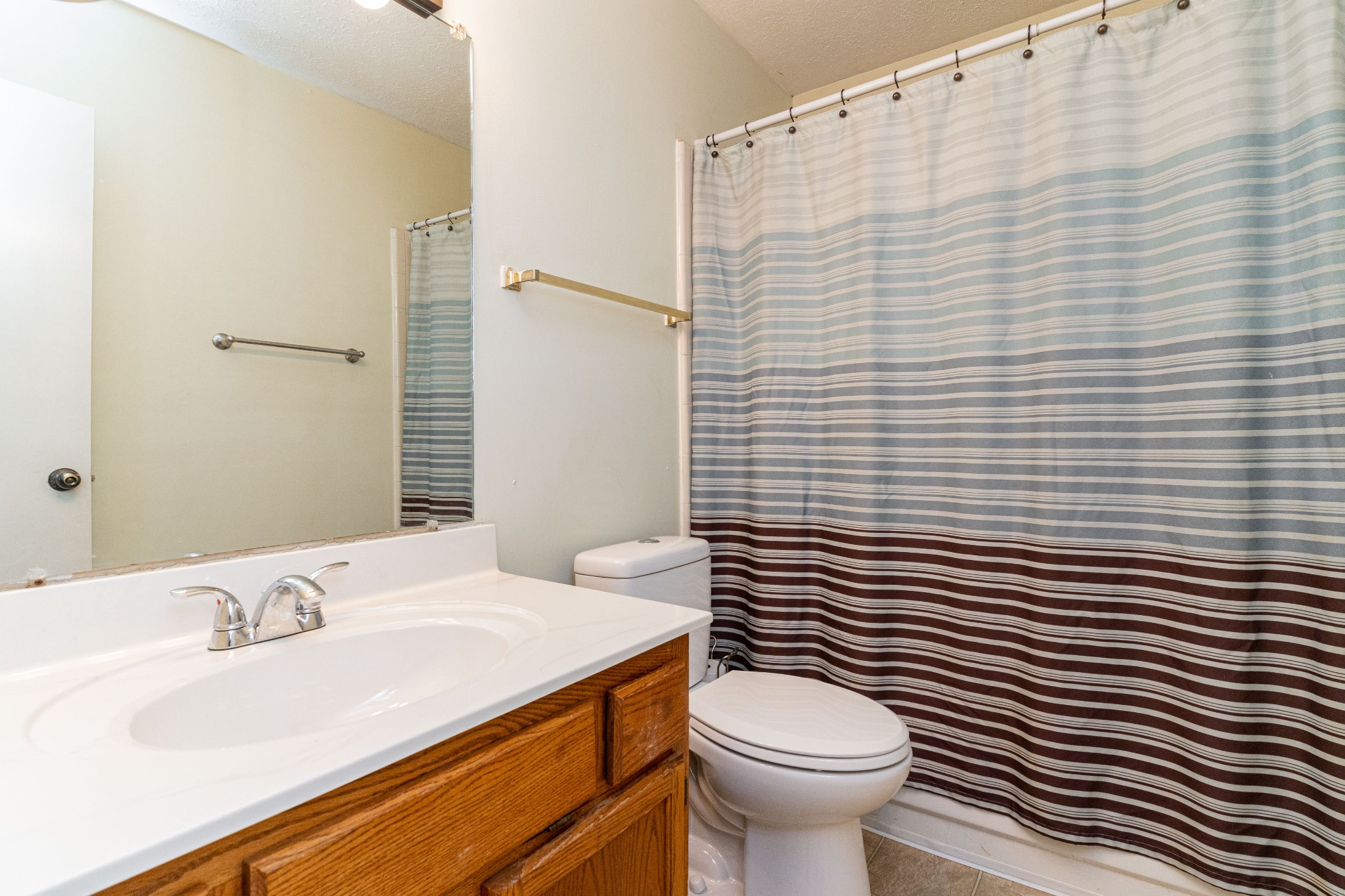 1016 Aldersgate Road Antioch, TN 37013 - Photo 21 of 31 a bathroom with a sink a toilet and shower curtain