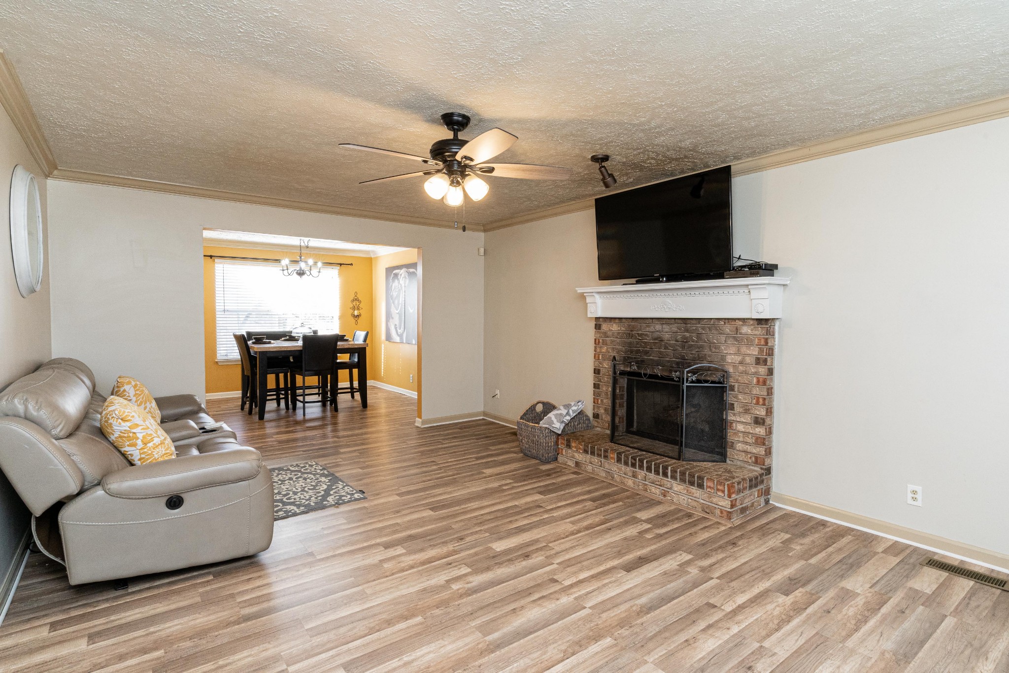 1016 Aldersgate Road Antioch, TN 37013 - Photo 8 of 31 a living room with furniture a fireplace and a flat screen tv